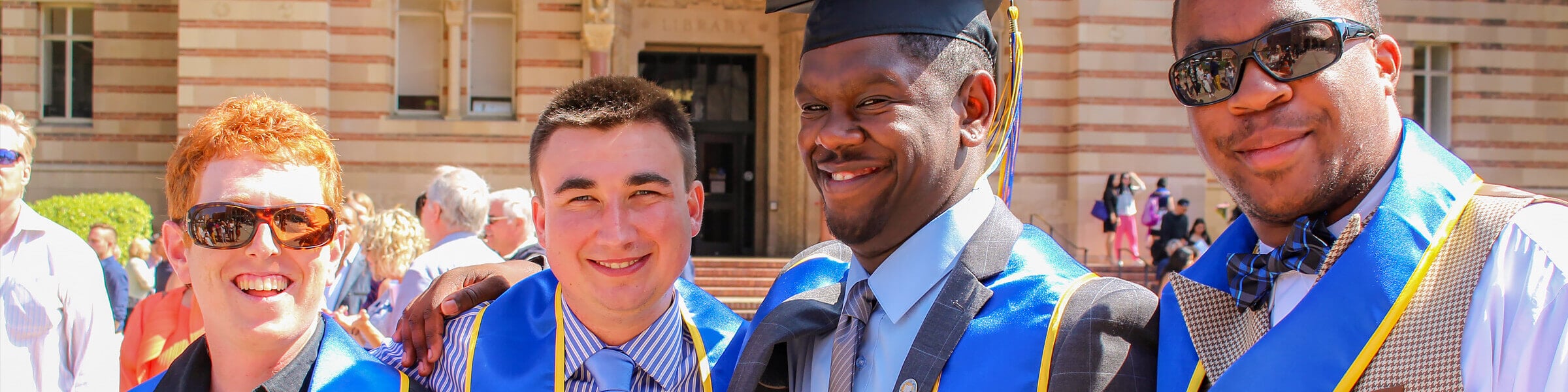 A college professor and a young man with Down syndrome carrying books share a happy moment