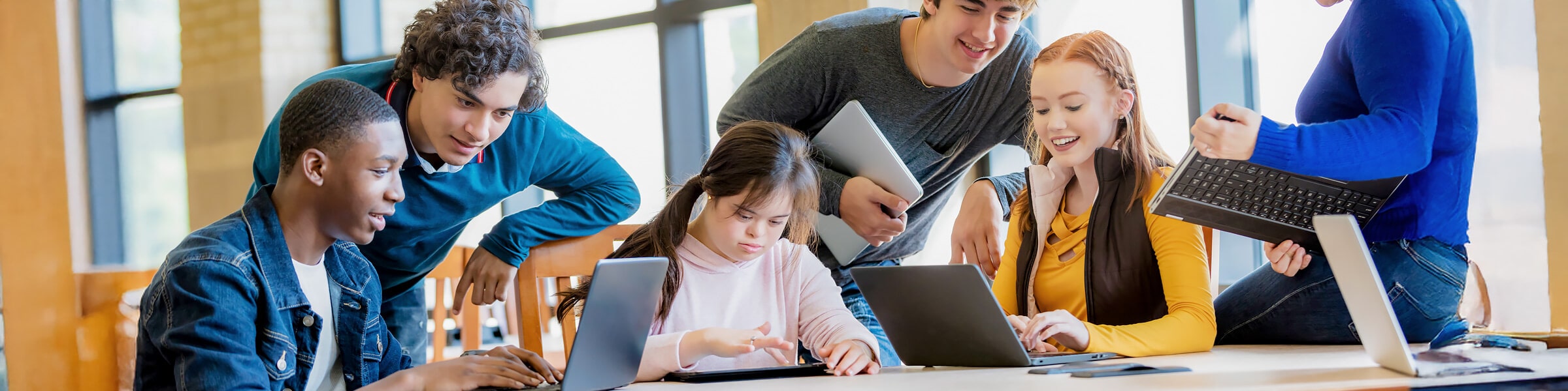 A girl with Down syndrome is joined by her schoolmates in a group study session