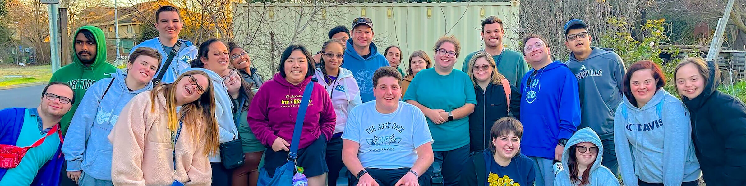 A happy group of students with diverse disabilities smile for the camera